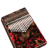 angled view of Meinl Sound Hole Designer Kalimba Lava KA17LV showing 17-note layout, engraved keys, acacia wood body, and lava artwork finish on white background