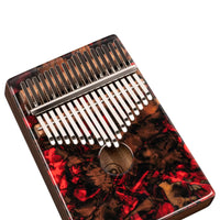 angled view of Meinl Sound Hole Designer Kalimba Lava KA17LV showing 17-note layout, engraved keys, acacia wood body, and lava artwork finish on white background