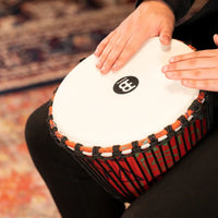 Close-up of hands playing the Meinl Travel Series Djembe Drum 10" Pharaoh's Script PADJ1-M-F.