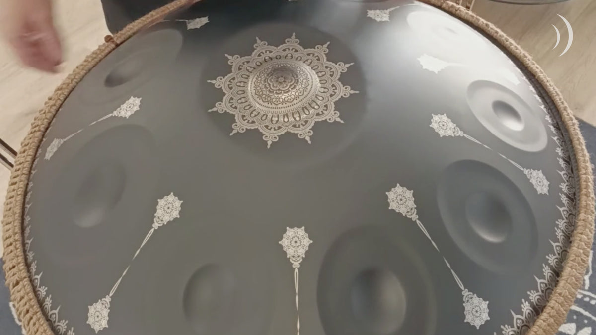 Mano Percussion ManoPan black handpan being played, demonstrating its warm resonant tone and sustained sound.