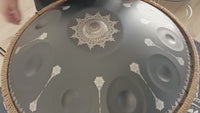 Mano Percussion ManoPan black handpan being played, demonstrating its warm resonant tone and sustained sound.