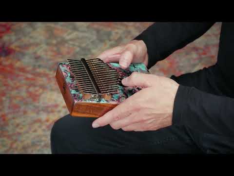 Meinl Sound Hole Designer Kalimba Coral Reef KA17CR being played to demonstrate warm melodic tones, rich resonance, and intuitive 17-note C Major tuning for relaxation, meditation, creative music making, and immersive sound exploration.