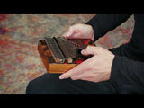 Meinl Sound Hole Designer Kalimba Lava KA17LV being played to demonstrate warm melodic tones, rich resonance, and intuitive 17-note C Major tuning for relaxation, meditation, creative music making, and immersive sound exploration.