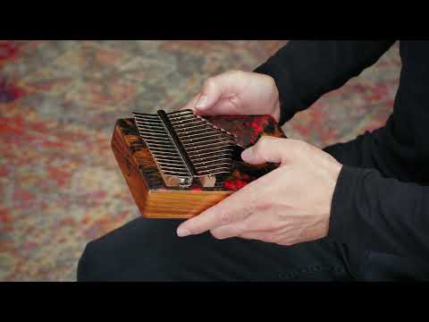 Meinl Sound Hole Designer Kalimba Lava KA17LV being played to demonstrate warm melodic tones, rich resonance, and intuitive 17-note C Major tuning for relaxation, meditation, creative music making, and immersive sound exploration.