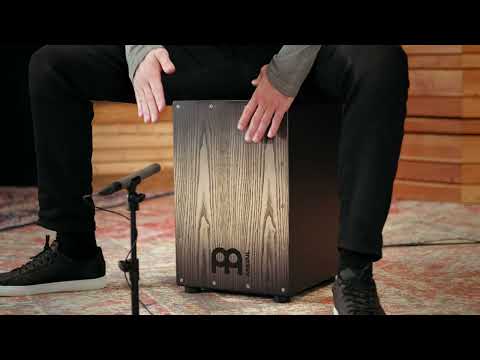 Performance video of a percussionist playing the Meinl Headliner Series Snare Cajon MCAJ100BK-CBF, demonstrating dynamic snare response, deep bass tones and expressive playing control